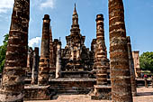 Thailand, Old Sukhothai - Wat Mahathat, the main chedi seen amongst the columns of the vihan. 